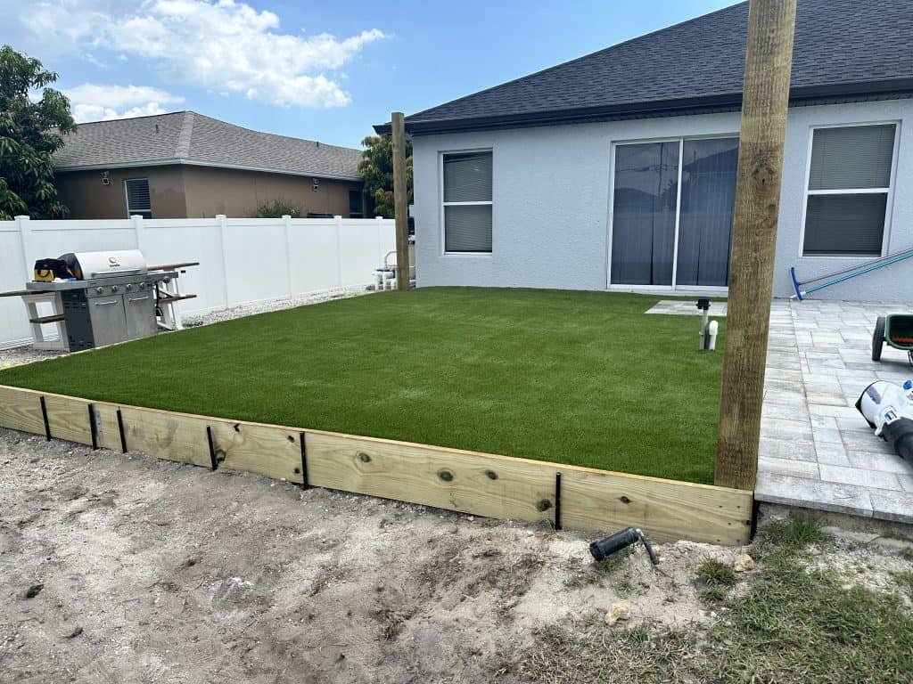 new house with a fake grass lawn